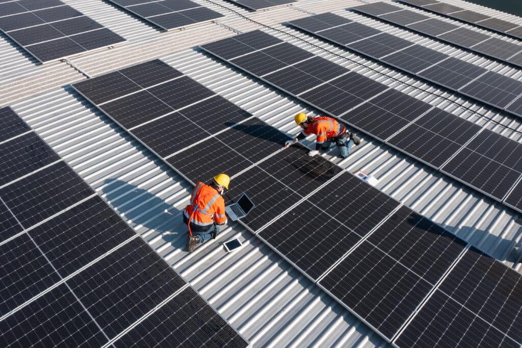 Technicians installing solar photovoltaic panels